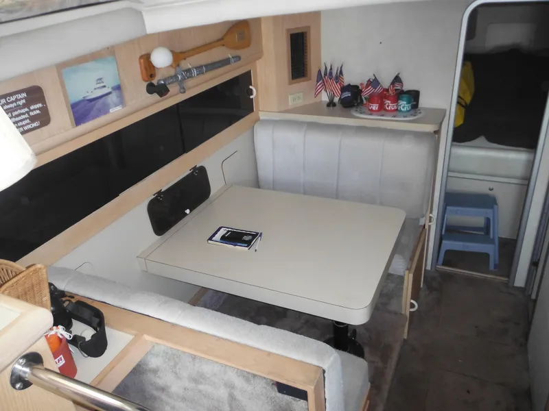Slide: The Image of Interior of 1990 Silverton 34 Convertible boat with dining area and table. - 11