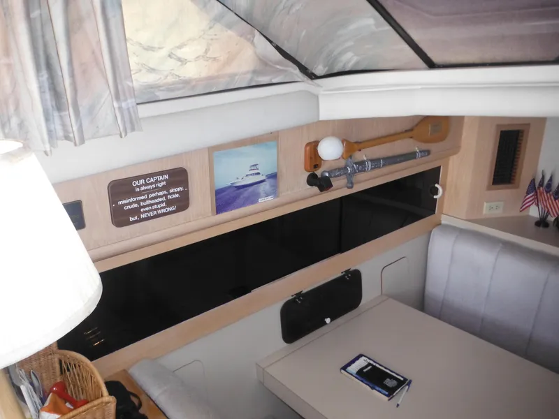 Slide: The Image of Interior of a 1990 Silverton 34 Convertible boat with dining area and decor. - 12