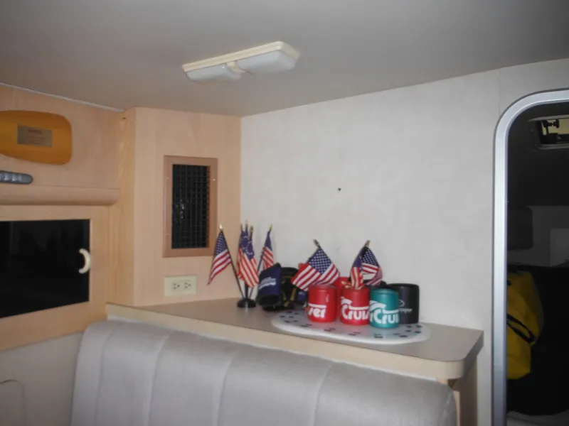 Slide: The Image of Interior of 1990 Silverton 34 Convertible with American flags and beverage holders. - 13
