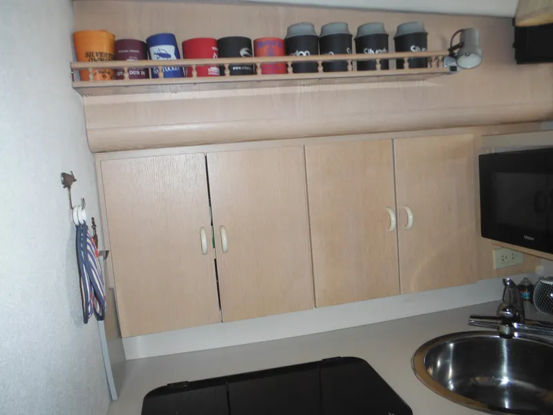 Slide: The Image of 1990 Silverton 34 Convertible kitchen with wooden cabinets and countertop. - 16