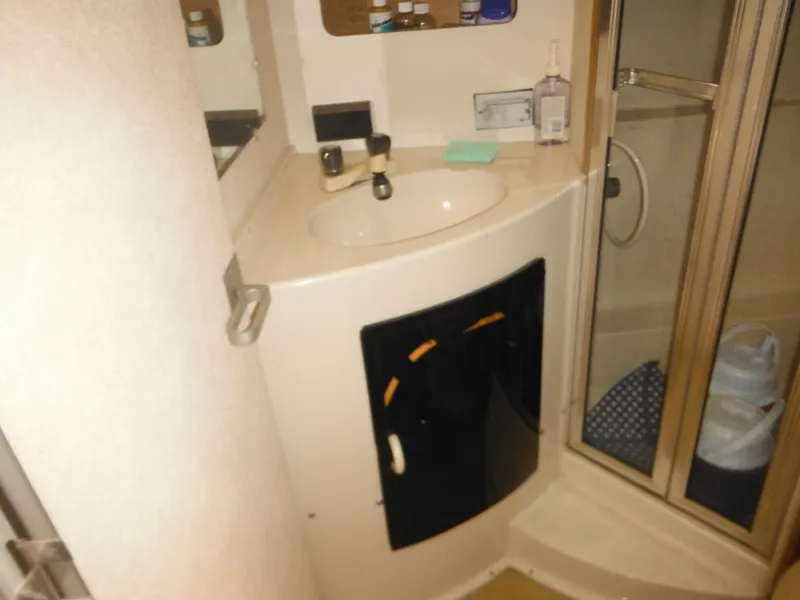 Slide: The Image of 1990 Silverton 34 Convertible bathroom with sink and shower. - 18