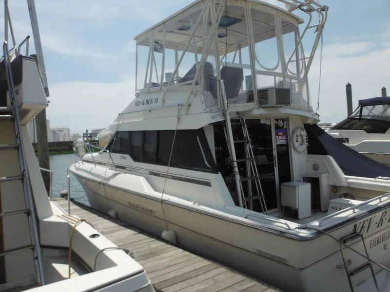 Slide: The Image of 1990 Silverton 34 Convertible yacht docked at marina. - 2