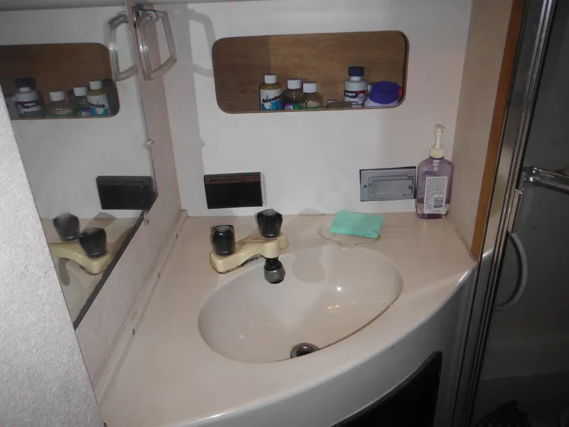 Slide: The Image of Bathroom sink area in a 1990 Silverton 34 Convertible boat. - 21