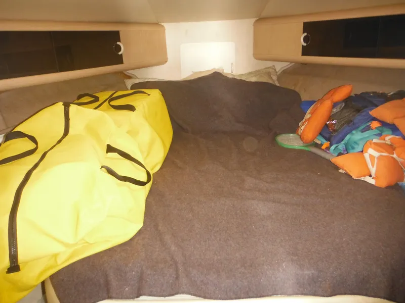 Slide: The Image of Interior cabin of a 1990 Silverton 34 Convertible boat with bed and storage. - 22