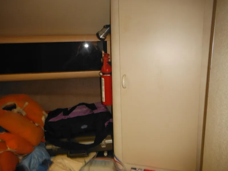 Slide: The Image of Interior cabin of a 1990 Silverton 34 Convertible boat with storage and safety equipment. - 24