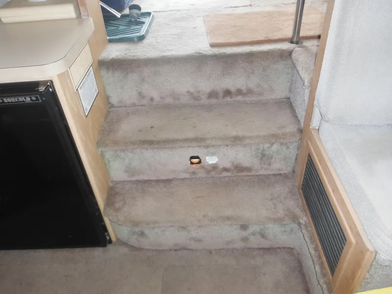 Slide: The Image of Interior steps of a 1990 Silverton 34 Convertible boat. - 30