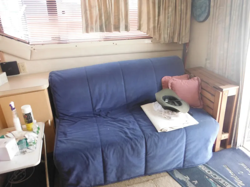 Slide: The Image of Interior of 1990 Silverton 34 Convertible with blue sofa and accessories. - 31