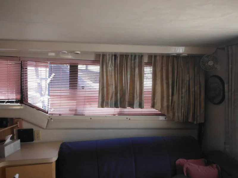 Slide: The Image of Interior of 1990 Silverton 34 Convertible with window blinds and curtains. - 32