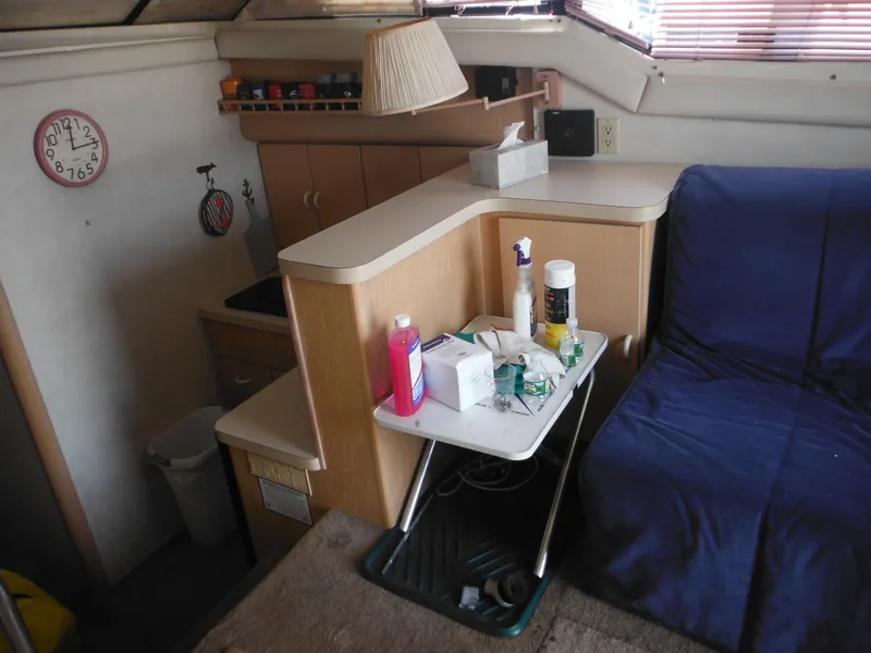 Slide: The Image of Interior of 1990 Silverton 34 Convertible boat with kitchenette and seating area. - 33