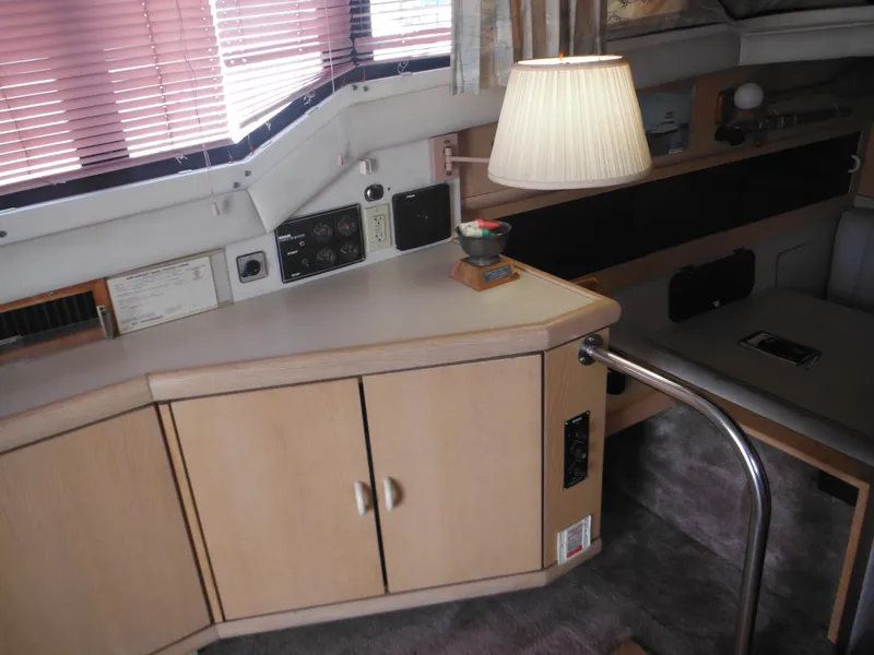 Slide: The Image of Interior of 1990 Silverton 34 Convertible yacht with wooden cabinets and lamp. - 35