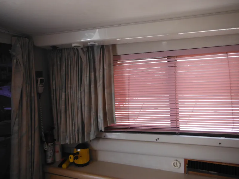 Slide: The Image of Interior of 1990 Silverton 34 Convertible with pink blinds and curtains. - 37