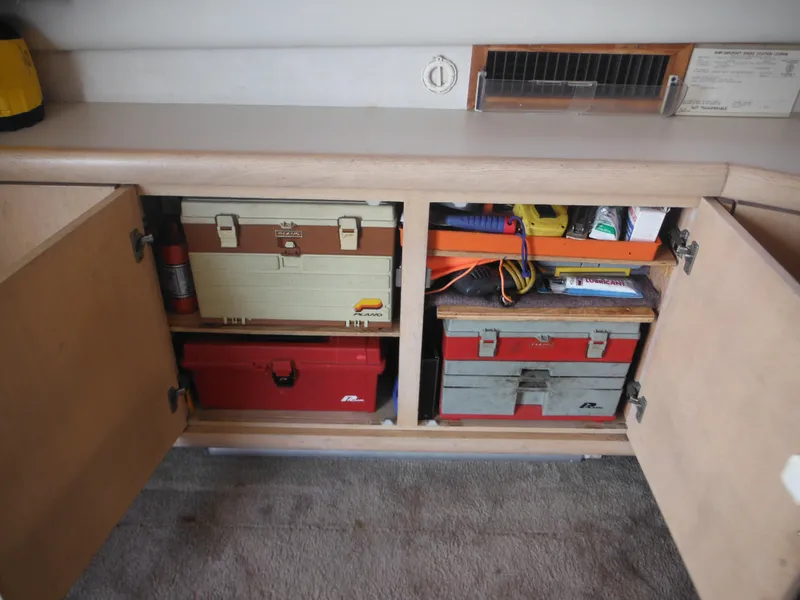 Slide: The Image of Storage cabinet with toolboxes and equipment on a 1990 Silverton 34 Convertible boat. - 40