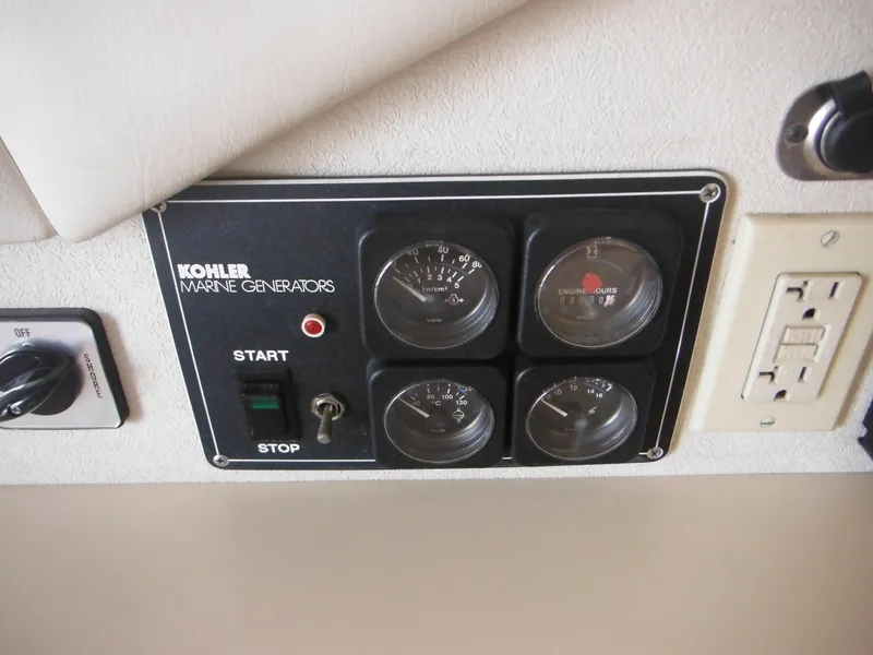 Slide: The Image of Control panel of Kohler marine generator on 1990 Silverton 34 Convertible boat. - 43
