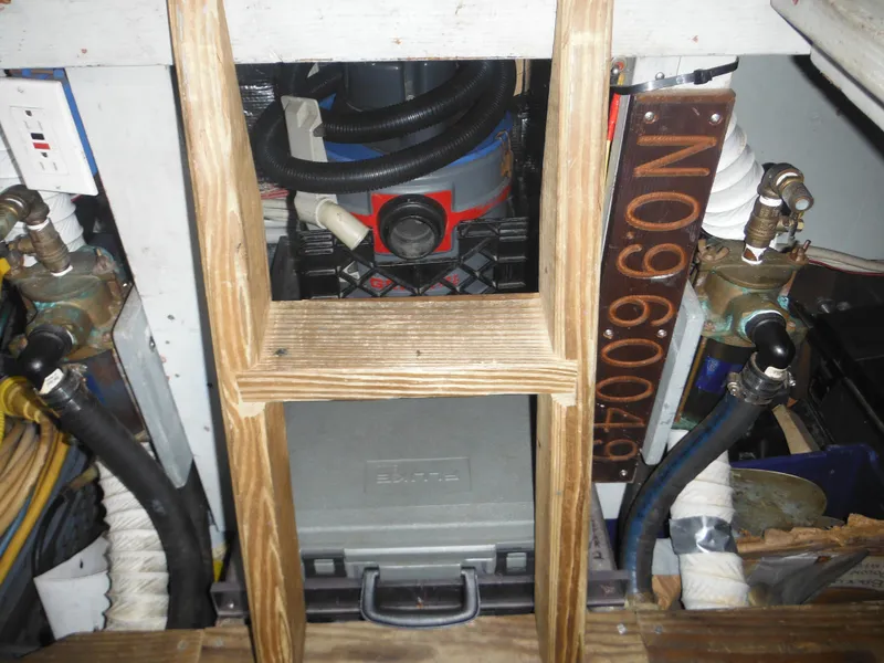 Slide: The Image of Engine compartment of a 1990 Silverton 34 Convertible boat with various equipment. - 48