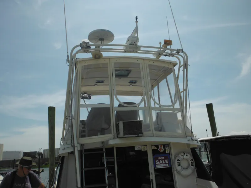 Slide: The Image of 1990 Silverton 34 Convertible boat for sale at a marina. - 5