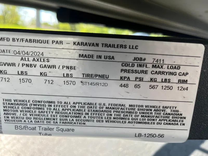 Slide: The Image of 2024 Lowe Jon L1648M Aura trailer label with specifications and safety standards. - 12