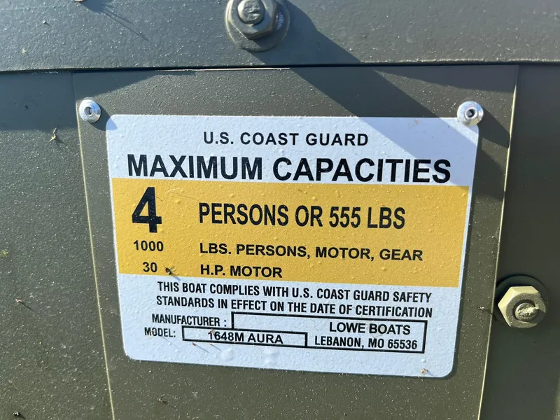 Slide: The Image of 2024 Lowe Jon L1648M Aura boat capacity label, U.S. Coast Guard compliant. - 14