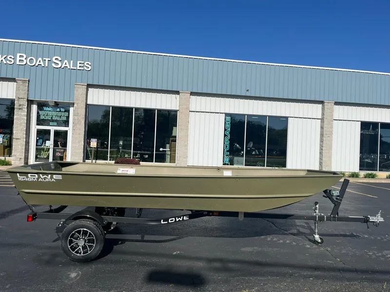 Slide: The Image of 2024 Lowe Jon L1648M Aura boat on trailer outside dealership. - 15