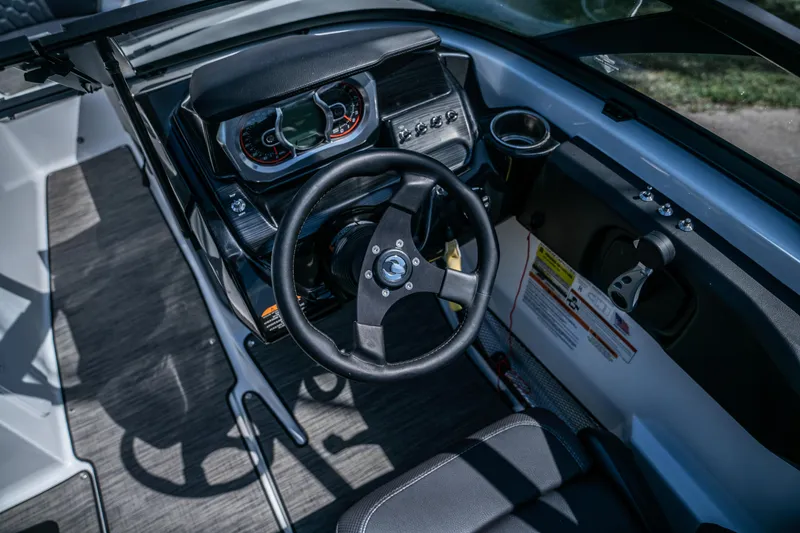 Slide: The Image of 2021 Scarab 195 boat dashboard and steering wheel. - 12