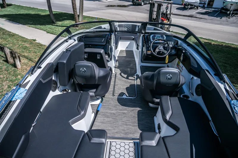 Slide: The Image of 2021 Scarab 195 boat interior with black seating and modern dashboard. - 9