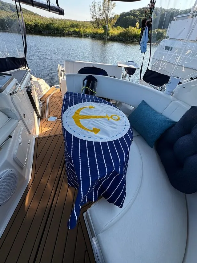 Slide: The Image of Interior of a 2008 Regal 3360 yacht with anchor-themed blanket. - 13
