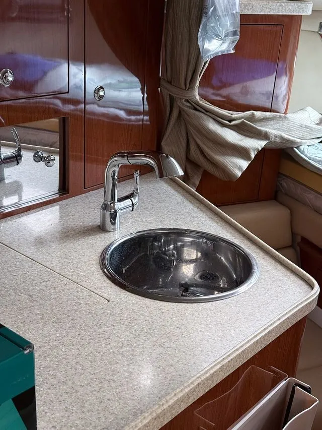 Slide: The Image of Interior of 2008 Regal 3360 Window Express with sink and wooden cabinets. - 14
