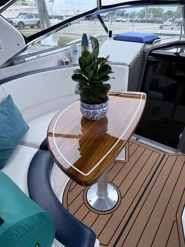 Slide: The Image of Interior of 2008 Regal 3360 Window Express boat with wooden table and plant. - 17