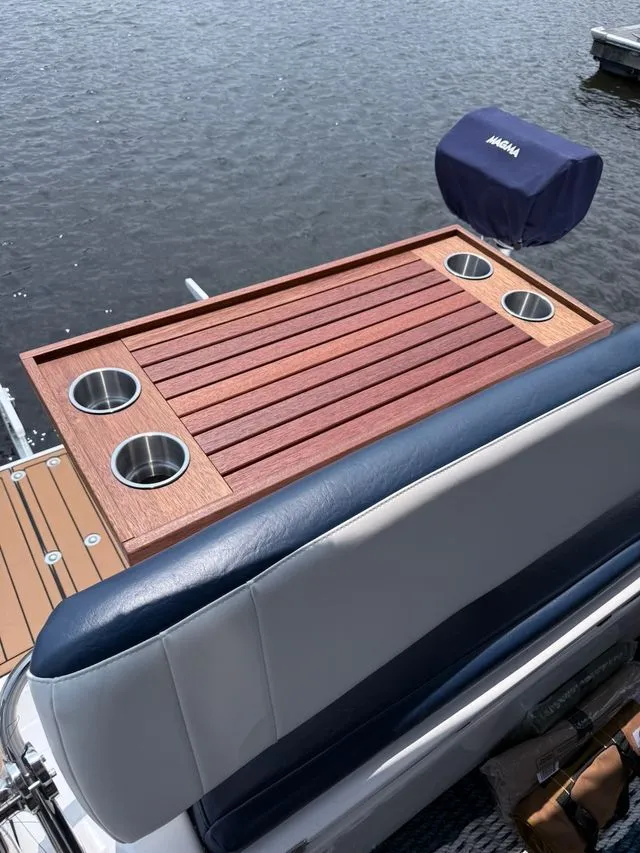 Slide: The Image of 2008 Regal 3360 boat with wooden table and cup holders. - 22