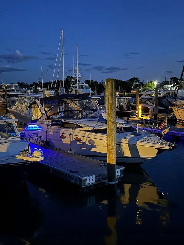 Slide: The Image of 2008 Regal 3360 Window Express boat docked at night. - 3