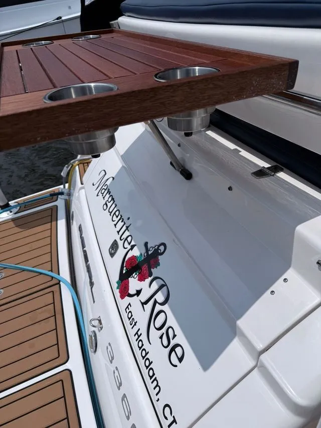 Slide: The Image of Regal 3360 Window Express boat with wooden table and cup holders. - 6