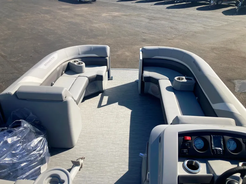 Slide: The Image of 2023 Bennington 22 SXSAPG pontoon boat interior with plush seating and modern dashboard. - 4