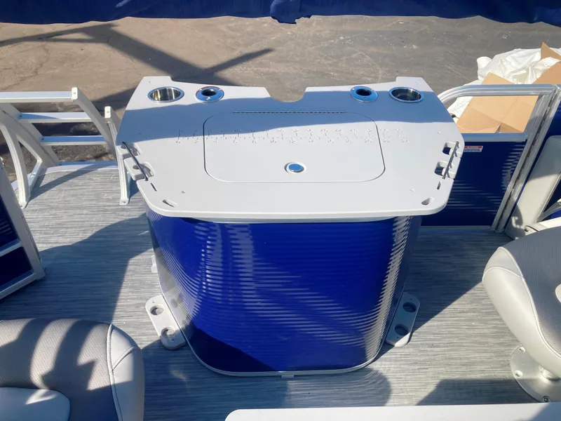 Slide: The Image of 2023 Bennington 22 SXSAPG boat interior with blue panel and seating area. - 7