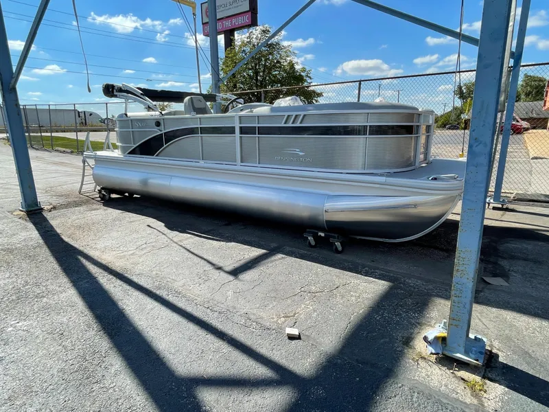 The Image of 2023 Bennington 22SXSR pontoon boat in a storage area. - 0