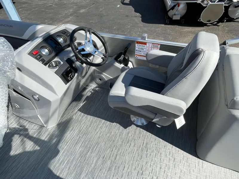 Slide: The Image of 2023 Bennington 22SXSR boat helm with steering wheel and captain's chair. - 7