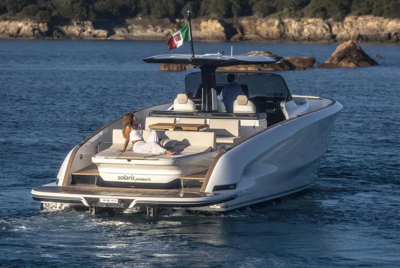 Slide: The Image of 2025 Solaris Power 44 Open yacht cruising with passengers, featuring sleek design and luxury amenities. - 1