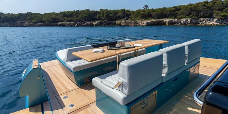 Slide: The Image of Luxurious seating area on the 2025 Solaris Power 44 Open yacht, anchored in a serene bay. - 13