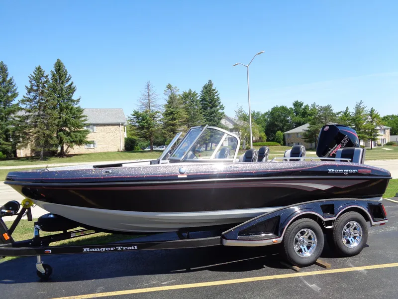 Slide: The Image of 2023 Ranger 1880 MS Angler boat on a trailer in a suburban area. - 3