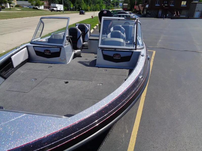 Slide: The Image of 2023 Ranger 1880 MS Angler boat with open deck and seating, parked on pavement. - 5