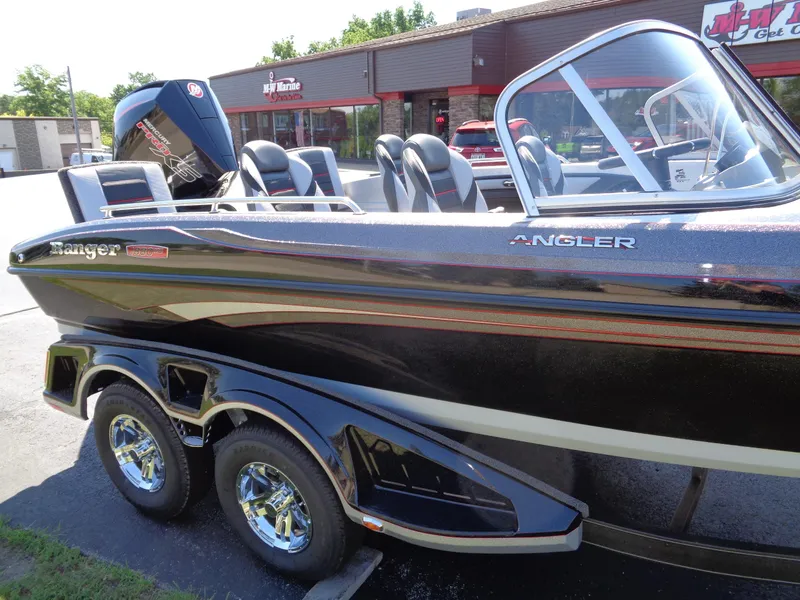 Slide: The Image of 2023 Ranger 1880 MS Angler boat with trailer, parked outside a dealership. - 7