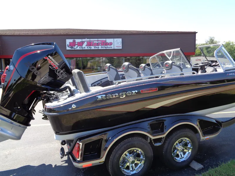 Slide: The Image of 2023 Ranger 1880 MS Angler boat displayed outside a dealership. - 9