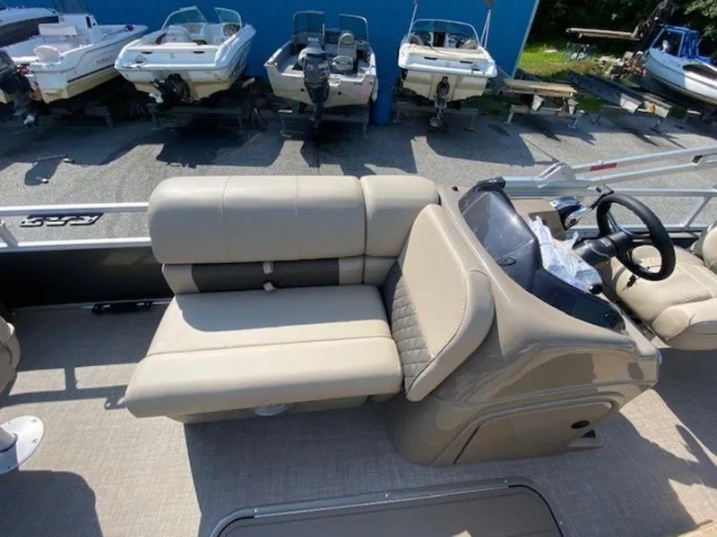 Slide: The Image of 2022 Sun Tracker FB 22 XP3 pontoon boat interior with beige seating and helm. - 10