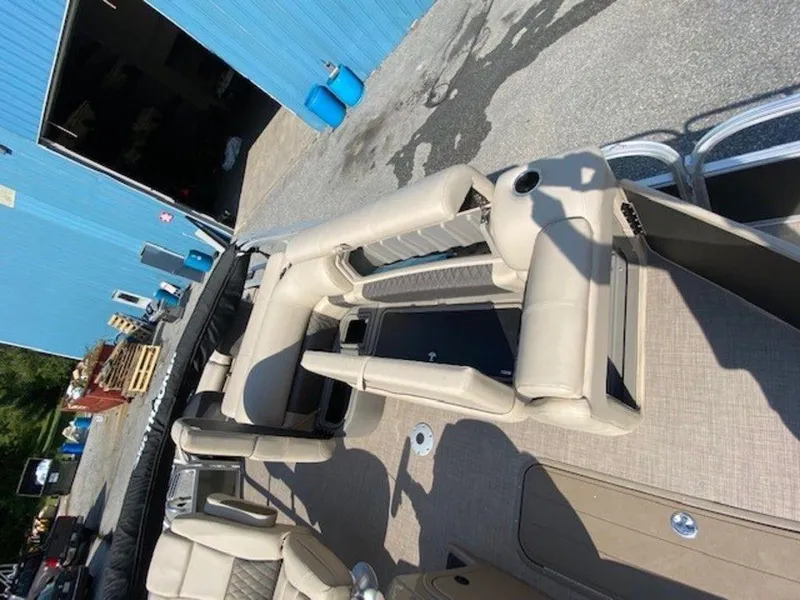 Slide: The Image of 2022 Sun Tracker FB 22 XP3 pontoon boat interior near blue building. - 7