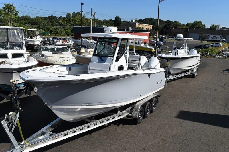 Slide: The Image of 2023 Blackfin 272CC boats on trailers in a marina parking lot. - 10