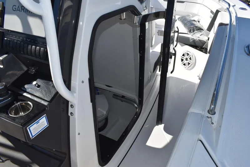 Slide: The Image of 2023 Blackfin 272CC boat interior with open door to cabin and visible toilet. - 11