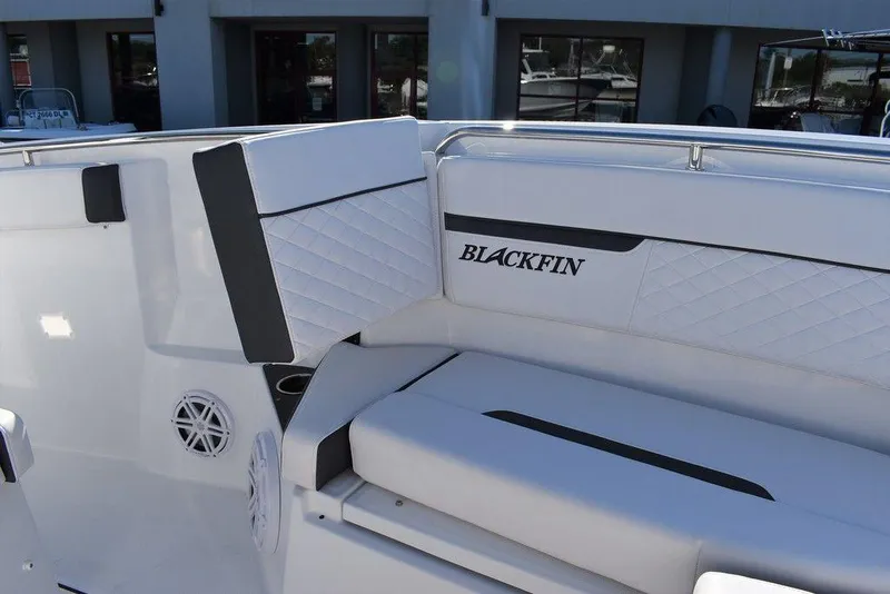 Slide: The Image of 2023 Blackfin 272CC boat interior seating with logo and speaker. - 21