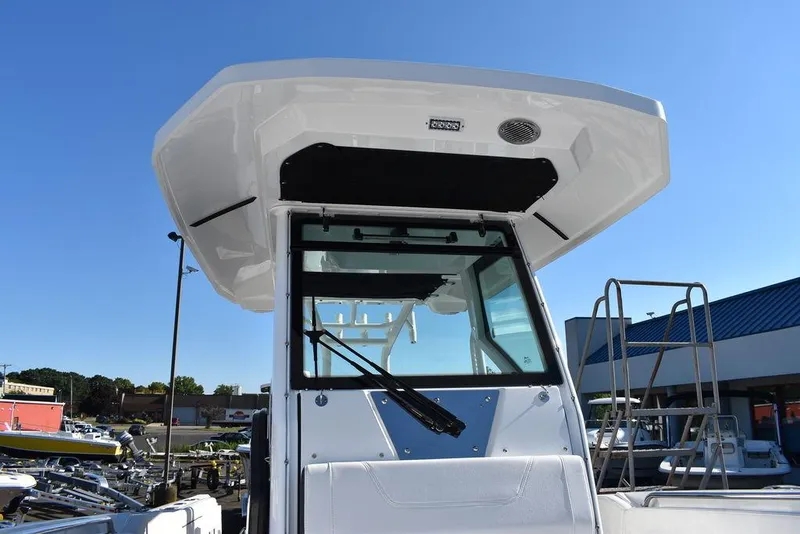 Slide: The Image of 2023 Blackfin 272CC boat with hardtop and windshield, docked at a marina. - 28