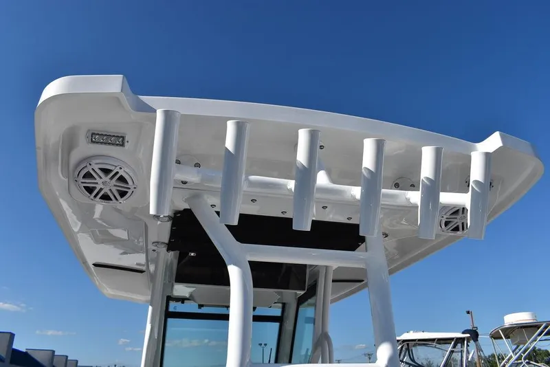 Slide: The Image of 2023 Blackfin 272CC boat with rod holders and speakers on the T-top. - 29