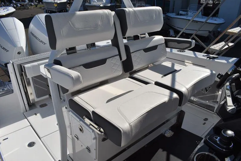 Slide: The Image of 2023 Blackfin 272CC boat with dual white cushioned seats and Mercury engines. - 31