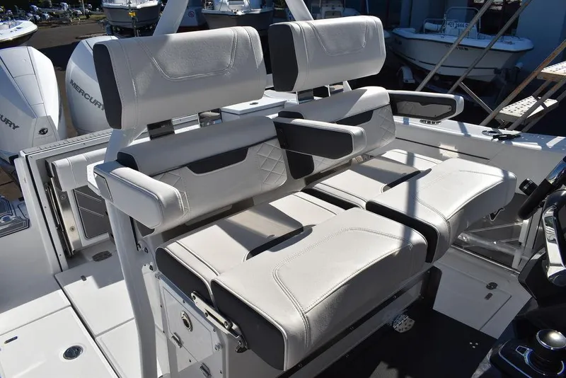 Slide: The Image of 2023 Blackfin 272CC boat with dual white cushioned seats and armrests. - 32