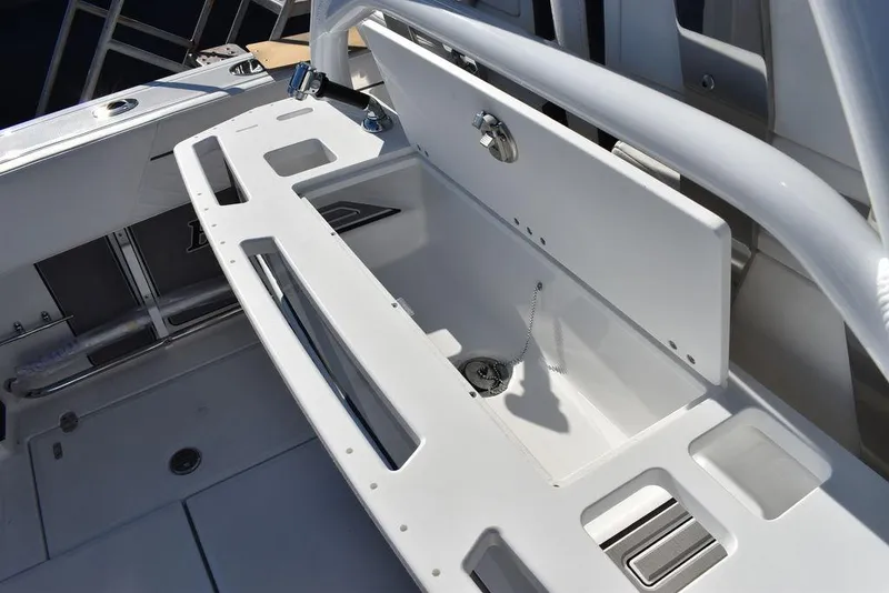 Slide: The Image of 2023 Blackfin 272CC boat with open storage compartment and clean white interior. - 41